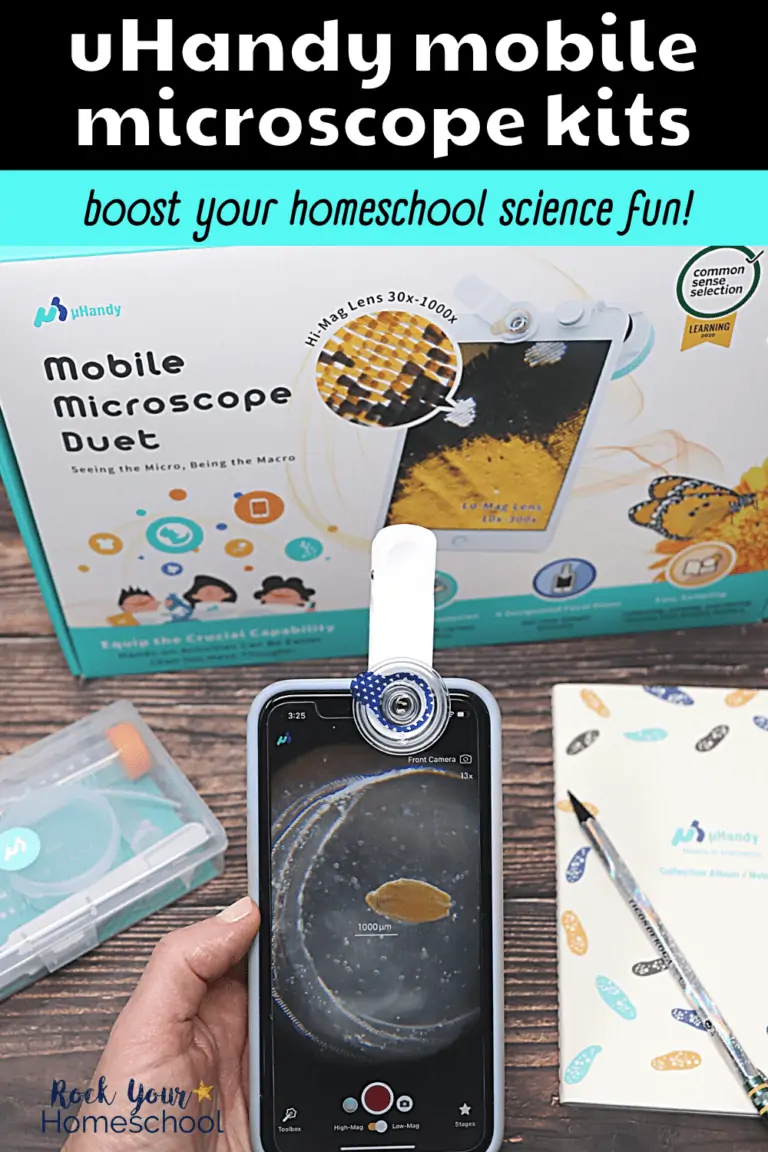 Woman holding smartphone with uHandy mobile microscope kit and notebook on wood surface